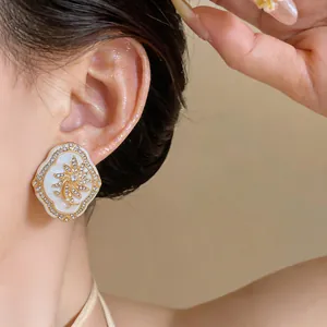 Close-up of vintage court style flower stud earring with rhinestones