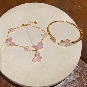 Elegant gold-plated butterfly bracelet and bangle jewelry set with pink charms and pearls
