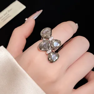 Exquisite detail of a luxury silver rhinestone butterfly open ring shown on a finger
