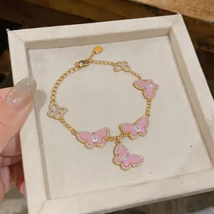 Close-up view of elegant pink enamel butterfly bracelet with sparkling zircon accents