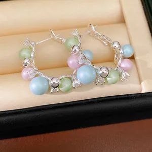 Elegant pastel pearl hoop earrings with rhinestones in a luxury jewelry box display