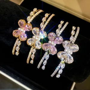 Elegant double-layered open bangles featuring sparkling zircon butterfly designs on velvet.