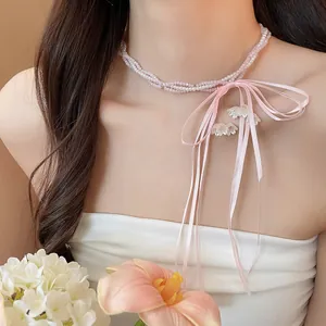 Elegant pink beaded necklace with silk bow and lily of the valley tassels
