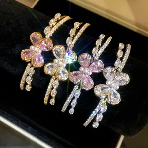 Close-up of sparkling zirconia butterfly double-layer open bracelets on black velvet display