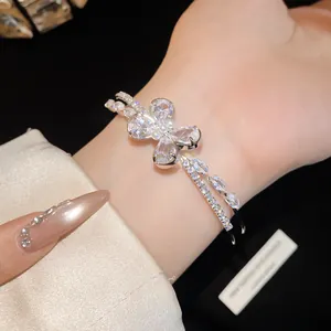 Detail view of an elegant zircon butterfly double-layer open bangle worn on a wrist