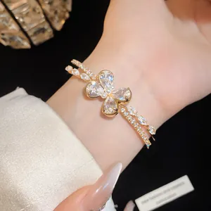 Close-up of double-layer gold butterfly bracelet with shimmering zircons and pearls
