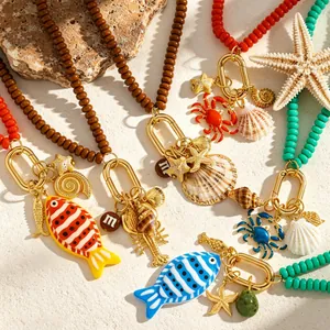 Primer plano de collares de playa de verano coloridos con amuletos de conchas y mar