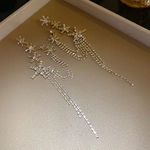 Detailed view of elegant silver needle star flower tassel dangle earrings for women