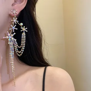 Detailed view of elegant silver earrings with sparkling rhinestone star flowers and tassels.