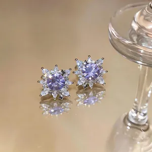 Detailed macro shot of sparkling purple flower ear clips with brilliant cubic zirconia