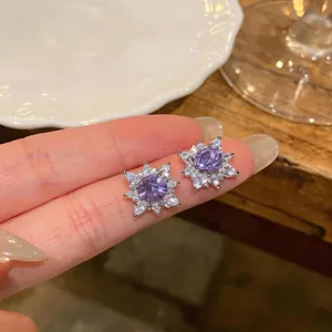 Detailed view of sparkling purple flower zircon earrings with a shimmering silver finish