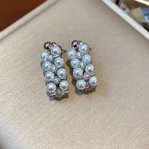 Detailed macro shot of French vintage pearl earrings with zircon embellishments