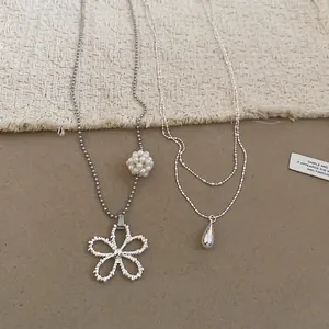 Elegant double-layered silver necklace set with flower and waterdrop pendants and pearl
