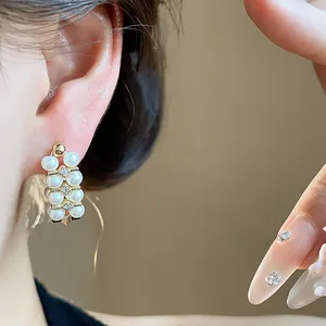Macro detail shot showing elegant French retro pearl stud earrings with zircon accents