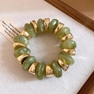 Elegant vintage green marbled bead bracelet with luxury gold-tone metal spacers