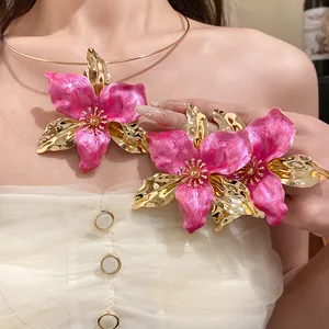 Detailed view of vintage pink enamel flower choker necklace and floral accessories