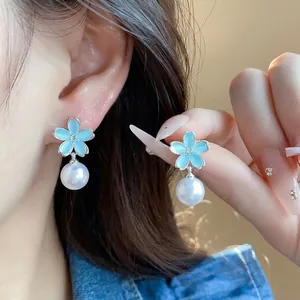 Elegant light blue enamel flower drop earrings with white pearls and silver needles