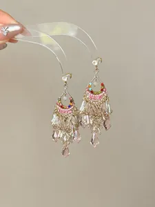 Detailed view of elegant ethnic style tassel earrings with pink teardrop crystals