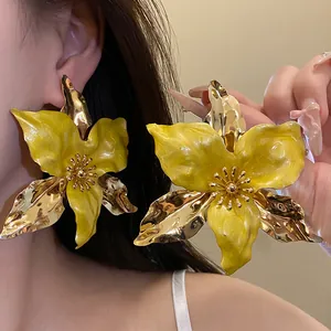 Detailed view of vintage yellow oil-dripped flower earrings with gold accents