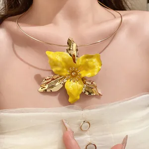 Detail view of a vintage yellow enamel flower choker necklace in ornate baroque style