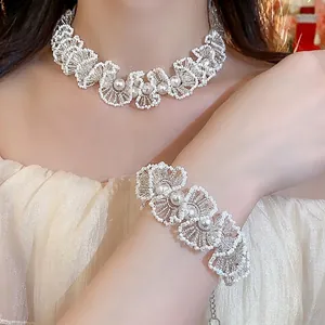 Elegant lace style beaded jewelry set with pearls including necklace and bracelet