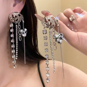 Elegant seashell tassel earrings with crystal strands and floral heart detail