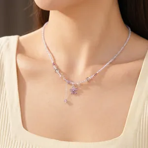 Elegant purple glass bead choker necklace featuring a sparkling zircon flower pendant on a model