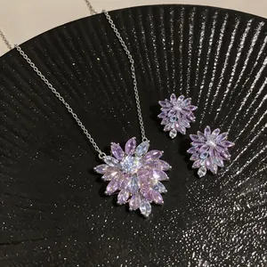 Close-up of sparkling purple and blue zircon flower necklace and stud earring set