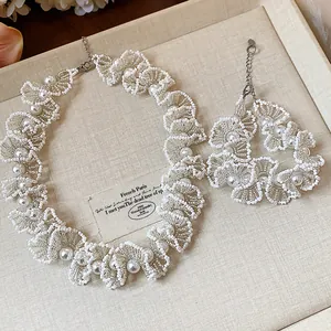 Elegant handmade beaded lace jewelry set with pearls featuring a stylish choker and bracelet