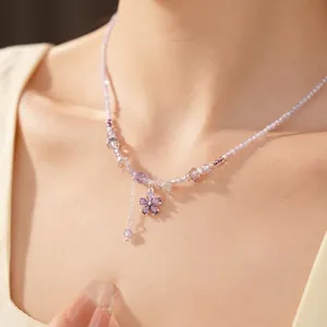 Elegant glass beaded necklace with purple zircon flower pendant on model