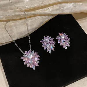 Close-up detail of the elegant purple zircon flower pendant and stud earrings set
