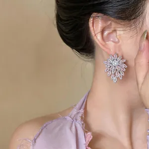 Elegant pink zircon flower stud earrings on model for a sophisticated look