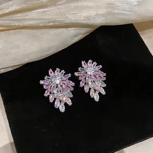 Macro detail view showing the elegant pink and clear zircon floral cluster stud earrings.