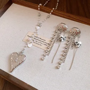 Elegant silver heart pendant necklace with white pearls and matching floral drop earrings