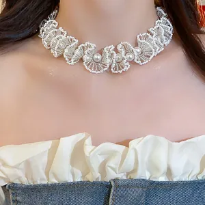 Close-up of elegant white glass beaded lace choker necklace with pearl accents