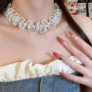 Close-up detail of an elegant white glass beaded lace choker with central pearls on model