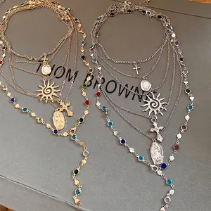 Elegant vintage multi-layered gold and silver necklace with sun cross pendants