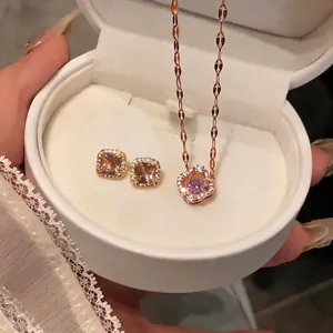 Rose gold jewelry set featuring champagne square studs and purple flower necklace