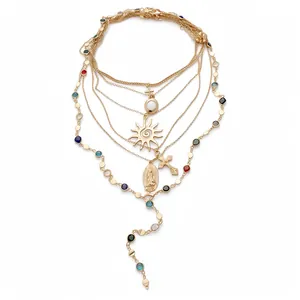 Elegant multi-layer gold necklace with cross, sun and Virgin Mary charm pendants