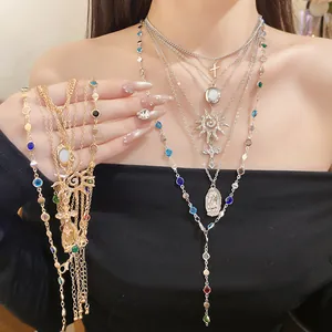 Close-up of multi-layer necklace with cross and sun pendants with colorful beads