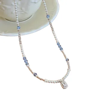 Elegant French style beaded pearl necklace featuring blue crystals and a zircon pendant