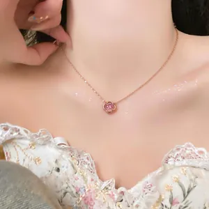 Delicate rose gold necklace featuring a pink zircon flower pendant worn by a model