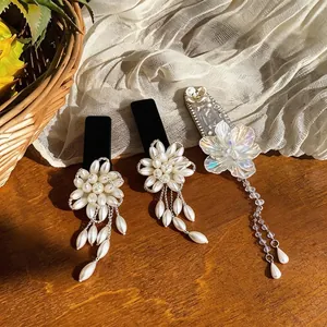 French style pearl flower hair clips with elegant long tassels on wooden background