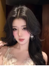 Close-up view of elegant metal chain pearl earrings on a model with a vintage aesthetic