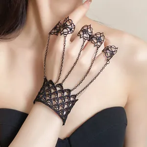 Detail shot of black lace hand chain with vintage filigree rings for women