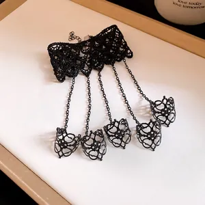 Detailed view of vintage gothic black lace slave bracelet with five connected rings
