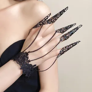 Detail of black lace wristband and hollow metal finger claws gothic ring bracelet set