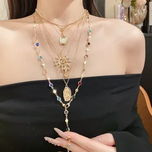 Detailed close-up showing a multi-layer gold necklace with religious cross and sun pendants.