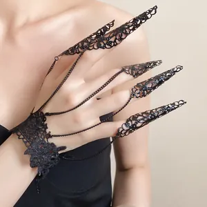 Close-up of gothic black lace bracelet with filigree metal claw rings for dark aesthetic