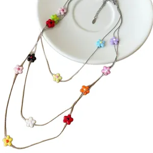 Multi-layered necklace with colorful resin flower beads for summer vacation style.